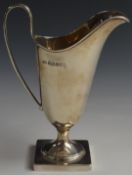 George V hallmarked silver jug of helmet shape raised on square base, Sheffield 1935, maker Viner'