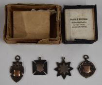 Four hallmarked silver watch chain fobs, various shapes including shield, Maltese Cross, eight point