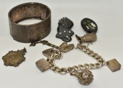 A silver charm bracelet, silver fob, Russian niello silver gun charm, white metal bangle, etc