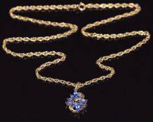 A 9ct gold necklace (length 56cm) set with marquise cut tanzanites and a diamond, 10.5g