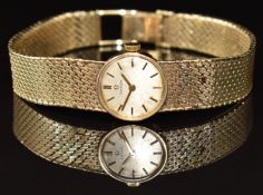 Omega 9ct gold ladies wristwatch with gold hands, two-tone hour markers, silver dial and signed