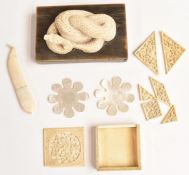 Oriental ivory game, carved snake on base, two mother of pearl sewing accessories and a ivory