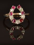 Victorian 15ct gold ring in the form of a horseshoe set with diamonds and rubies, size R, 3g
