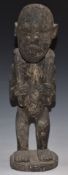 African tribal carved figure carrying dead game, H39cm