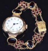 A 9ct gold ladies watch with 9ct gold strap set with garnets, 23.2g
