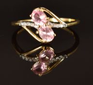 A 9ct gold ring with two pink topaz and diamonds, size P/Q, 2g