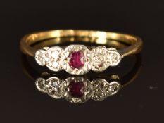 An 18ct gold ring set with a ruby and diamonds in a platinum setting, size O/P, 1.9g