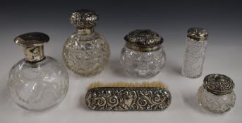 Five hallmarked silver lidded glass dressing table pots and bottles together with a hallmarked