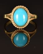 A 9ct gold ring set with a faux turquoise cabochon, size N, 2.6g