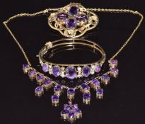 A silver gilt necklace set with amethysts, a bangle set with amethysts and a Victorian brooch