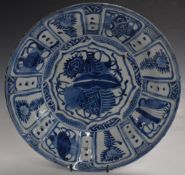 An 18thC or earlier Chinese blue and white dish decorated with flowers and auspicious symbols,