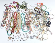 A collection of jewellery including beaded necklaces, 9ct gold cameo ring, silver charms, silver