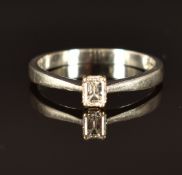 An 18ct white gold ring set with an emerald cut diamond of approximately 0.25ct, with original