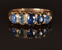 A c1900 9ct gold ring set with five sapphires, size J/K, 3.1g