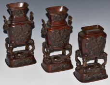A set of three Japanese bronze pedestal censers decorated with mythical creatures, with lion head