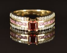 A 9k gold ring set with a garnet, pink sapphires and diamonds, size M, 4.2g
