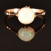 A 9ct rose gold ring set with an opal cabochon, size K, 1.4g