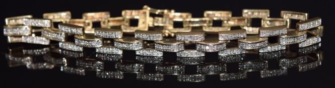 A 9ct gold bracelet set with diamonds in a buckle design, 14g