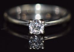 A 9ct white gold ring set with a round cut diamond of approximately 0.27ct, in original box, size I,