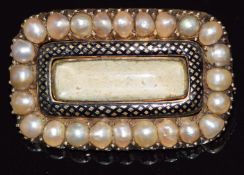 Victorian mourning brooch set with split pearls and enamel, with glass compartment to the centre