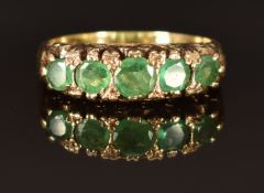 A 9ct gold ring set with emeralds size P, 4.8g