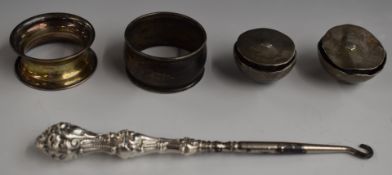 Two hallmarked silver napkin rings, pair of white metal heavy horse harness or similar adornments