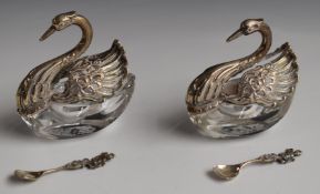 Pair of continental white metal and cut glass novelty salts formed as swans, together with two