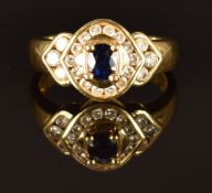 An 18ct gold ring set with a sapphire and diamonds, size K/L, 6.3g