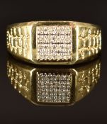 A 10k gold ring set with diamonds in a square setting, size V, 4.8g