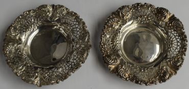 Victorian pair of hallmarked silver bon bon dishes with pierced and embossed decoration, Chester