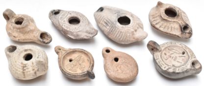 Eight Roman / Roman style oil lamps, some with figural decoration, length of longest 11cm