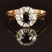 An 18ct gold ring set with a sapphire surrounded by diamonds in a platinum setting, size O, 2.7g