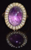Victorian ring set with a foiled amethyst cabochon surrounded by seed pearls, size M/N, 6g