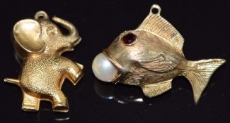A 9ct gold elephant pendant and a 9ct gold fish pendant, set with garnet eyes and a pearl in its
