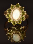 A 9ct gold ring set with an opal surrounded by peridot, size K/L, 3.7g