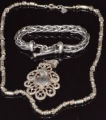 A silver necklace by Megido, silver bracelet and white metal pendant