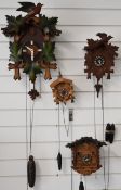 Four mid 20thC German cuckoo clocks, tallest 45cm