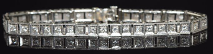 A 14k white gold tennis bracelet set with 38 round cut diamonds, total diamond weight