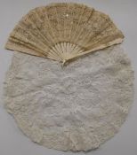 A 19thC carved bone and lace fan and a circular piece of lace, L22.5cm