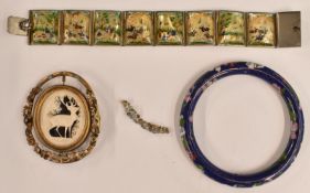 A white metal bracelet set with painted mother of pearl panels, a cloisonné bangle and a Victorian