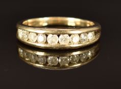 A 9ct gold ring set with nine round cut diamonds, size V, 5.4g