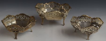 George V set of three hallmarked silver pierced hexagonal bon bon dishes raised on three feet,
