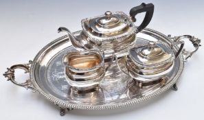 Oval twin handled silver plated tray and a silver plated three piece teaset, length of tray 62cm