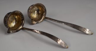 George V pair of hallmarked silver Arts & Crafts chocolate ladles with hammered decoration Sheffield