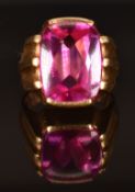 A 14k gold ring set with a pink cushion mixed cut synthetic pink sapphire, size N/O, 15.1g