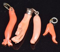 Victorian carved coral charm in the form of a hand holding an object, and three other Victorian