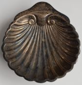 George V hallmarked silver shell shaped dish, raised on three ball feet, Sheffield 1933, maker