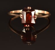 A 9ct gold ring set with a garnet, size N, 1.2g