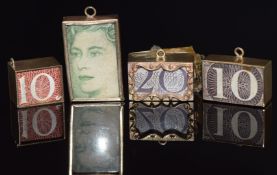 Four 9ct gold charms set with shilling notes