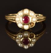 A 9ct gold ring set with a ruby surrounded by pearls, size M, 2.8g